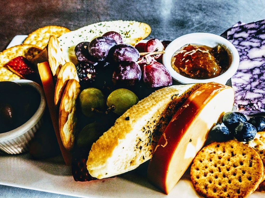 charcuterie board with apples, bread, crackers, and grapes with jelly in Pittsburgh at R Wine Cellar