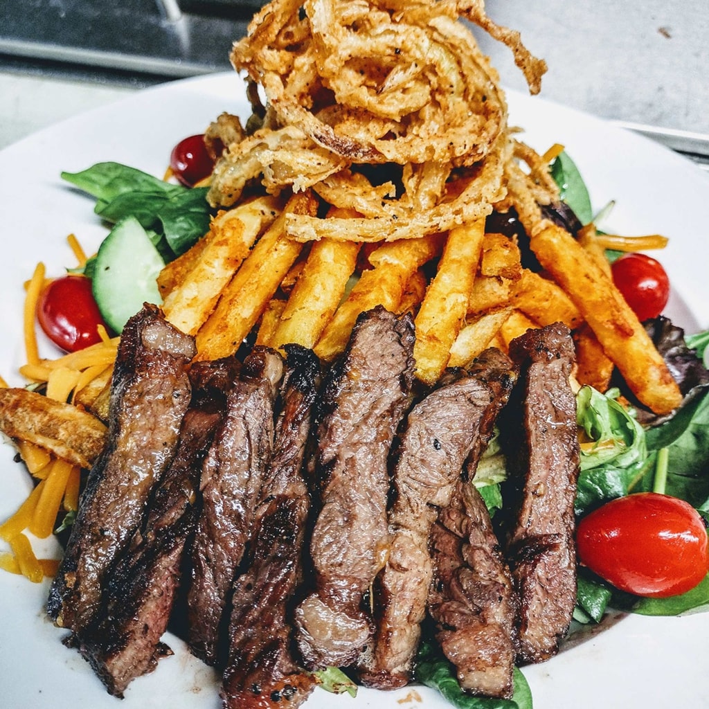 steak and fries on a sald at R Wine Cellar on Penn Ave