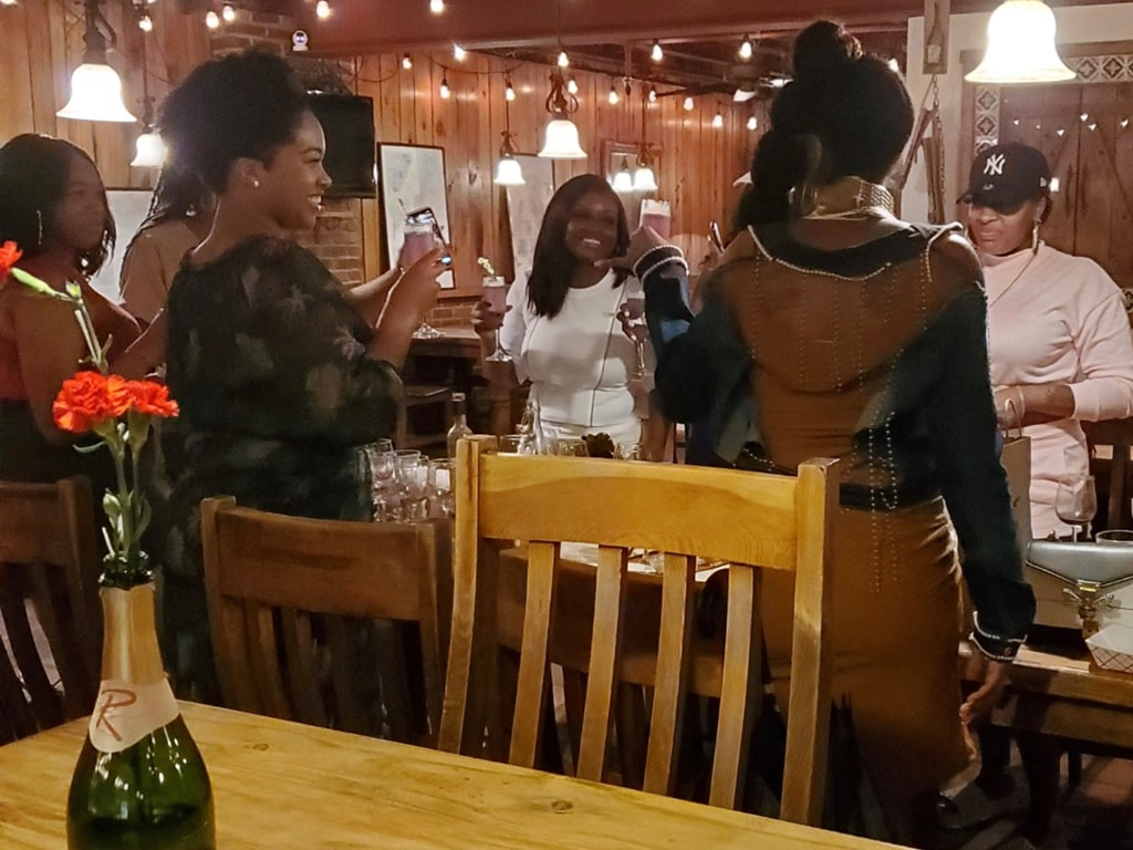 People at an event at R Wine Cellar on Penn Ave